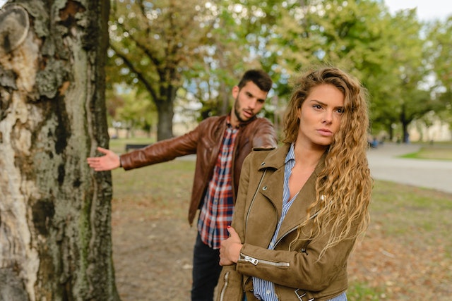 man trying to explain something to a woman with her back turned